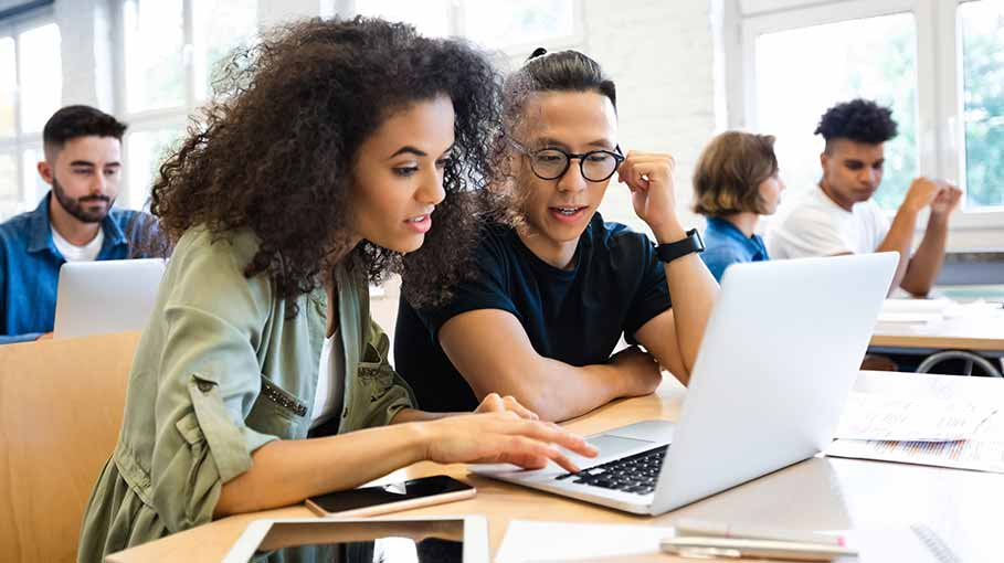 two girls in office with laptop